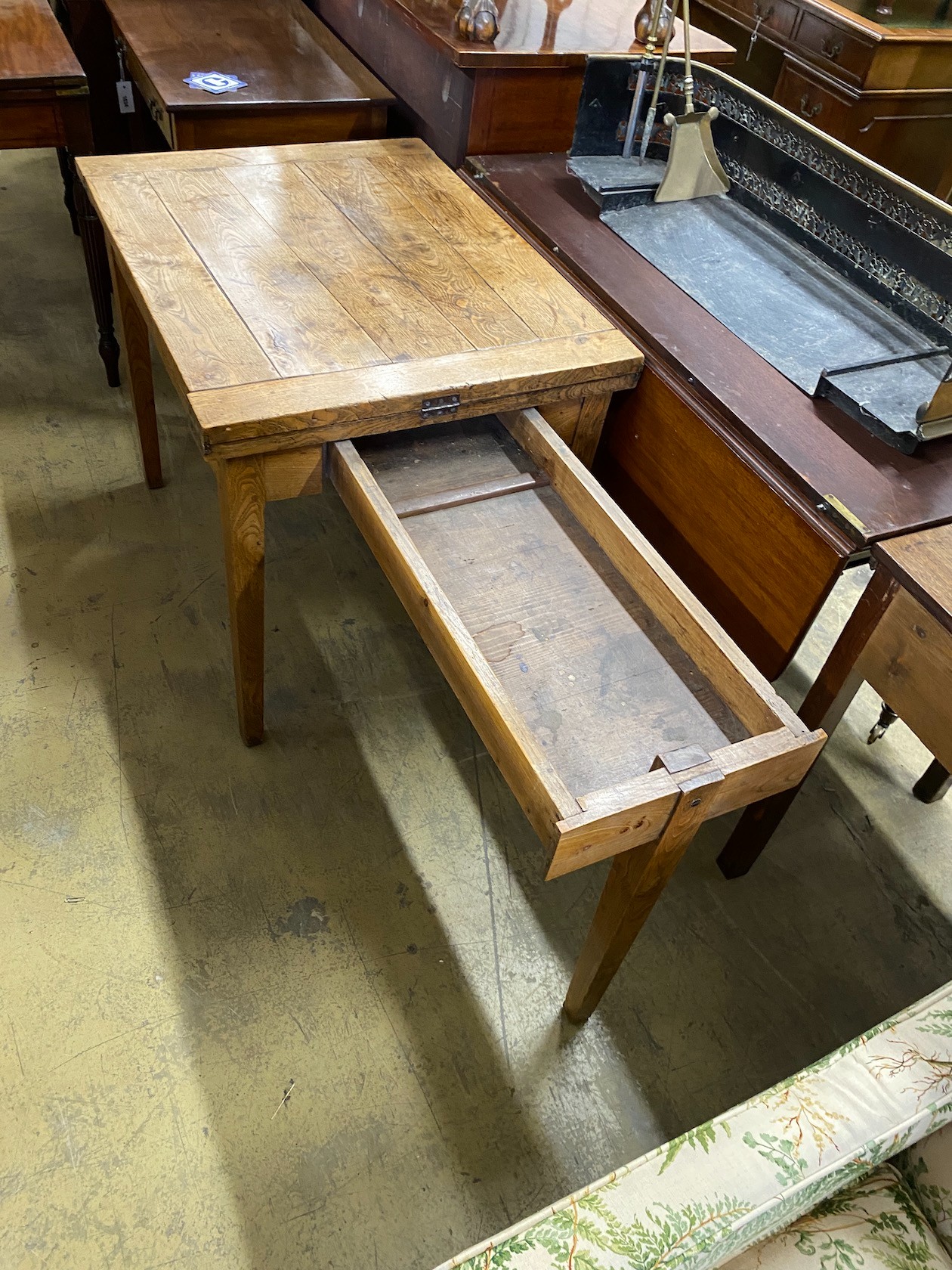A 19th century French provincial oak farmhouse table with rectangular folding top on square tapered legs, 176cm extended, depth 69cm, height 74cm